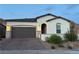 Charming single-story home featuring desert landscaping, a brick driveway, and a two-car garage at 80 Cathedral Wash Pl, Henderson, NV 89011
