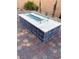 Stylish gas firepit with tile accents for an outdoor living area at 80 Cathedral Wash Pl, Henderson, NV 89011