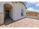 Home front porch features brick-paved entrance with arched doorway and stone pillar at 80 Cathedral Wash Pl, Henderson, NV 89011