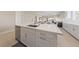 Stylish kitchen island with quartz countertop, stainless steel sink, and contemporary cabinetry at 80 Cathedral Wash Pl, Henderson, NV 89011