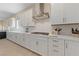 Bright kitchen features white cabinets, stainless steel appliances, and sleek countertops at 80 Cathedral Wash Pl, Henderson, NV 89011