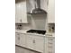 Modern kitchen featuring white cabinets, quartz countertops, and gas stovetop at 80 Cathedral Wash Pl, Henderson, NV 89011
