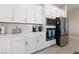 Modern kitchen features white cabinets, stainless steel appliances, and sleek countertops at 80 Cathedral Wash Pl, Henderson, NV 89011