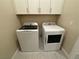 Bright laundry room featuring modern appliances and ample storage space with white cabinets at 80 Cathedral Wash Pl, Henderson, NV 89011