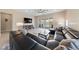 Comfortable living room with a large sectional sofa, ceiling fan, and access to the backyard at 80 Cathedral Wash Pl, Henderson, NV 89011