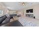 Bright, open-concept living space with a large sectional sofa and entertainment center at 80 Cathedral Wash Pl, Henderson, NV 89011