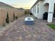 An outdoor living area with brick pavers and a stylish fire pit ready for entertaining at 80 Cathedral Wash Pl, Henderson, NV 89011