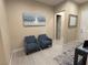 Comfortable sitting area features two blue armchairs and art at 80 Cathedral Wash Pl, Henderson, NV 89011
