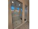 Modern walk-in shower featuring sleek marble tiling, glass enclosure, and natural light for a spa-like experience at 80 Cathedral Wash Pl, Henderson, NV 89011