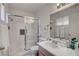 Bathroom featuring a shower with glass door, a sink with vanity, and a large mirror at 8048 Astrology Ct # 201, Las Vegas, NV 89128