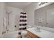 Bathroom features a shower with curtain, vanity with a large mirror, and white tiled walls at 8048 Astrology Ct # 201, Las Vegas, NV 89128
