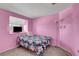Cozy bedroom featuring plush carpeting and a tropical-themed bedspread with floral accents at 8048 Astrology Ct # 201, Las Vegas, NV 89128