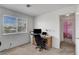 Bright home office space with modern desk, rolling office chair, and large window at 8048 Astrology Ct # 201, Las Vegas, NV 89128