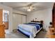 Well-lit bedroom with ceiling fan, closet with sliding doors, and stylish blue and white bedding at 8048 Astrology Ct # 201, Las Vegas, NV 89128
