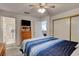 Bedroom featuring a closet with sliding doors, ceiling fan, TV on dresser, and ensuite bathroom at 8048 Astrology Ct # 201, Las Vegas, NV 89128