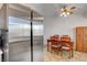 Cozy dining room features a wooden table, matching chairs, ceiling fan, and stainless steel refrigerator at 8048 Astrology Ct # 201, Las Vegas, NV 89128