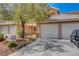 Inviting two-story home with a two-car garage, low-maintenance yard, and driveway parking at 8048 Astrology Ct # 201, Las Vegas, NV 89128