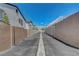 Wide security gate securing an alleyway between two privacy walls with clear blue skies above at 8048 Astrology Ct # 201, Las Vegas, NV 89128