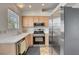 Modern kitchen featuring stainless steel appliances, light wood cabinets, and ample counter space at 8048 Astrology Ct # 201, Las Vegas, NV 89128