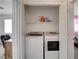 Laundry area with a washer, dryer, and shelving for storage, conveniently located near the bedroom at 8048 Astrology Ct # 201, Las Vegas, NV 89128
