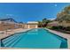 Community pool with blue water, multiple access points, and pool house against a blue sky backdrop at 8048 Astrology Ct # 201, Las Vegas, NV 89128
