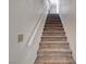 Carpeted stairway with white walls and a white railing to the second floor at 8048 Astrology Ct # 201, Las Vegas, NV 89128