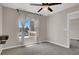 Empty bedroom featuring a ceiling fan, large window, and floating shelves at 8070 W Russell Rd # 2052, Las Vegas, NV 89113