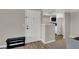 Inviting entryway with modern floors, bench, and a view into the kitchen at 8070 W Russell Rd # 2052, Las Vegas, NV 89113