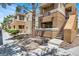 Condo exterior with manicured landscaping, staircase and private balconies at 8070 W Russell Rd # 2052, Las Vegas, NV 89113
