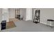 Open-concept living room boasts neutral tones, carpet, and modern shelving and decor at 8070 W Russell Rd # 2052, Las Vegas, NV 89113