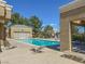 Outdoor swimming pool surrounded by lounge chairs and mature landscaping at 8070 W Russell Rd # 2052, Las Vegas, NV 89113
