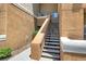 An exterior staircase provides access to upper-level units with textured walls at 8070 W Russell Rd # 2052, Las Vegas, NV 89113