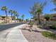 Street view with beautiful landscaping and palm trees lining the street at 8070 W Russell Rd # 2052, Las Vegas, NV 89113