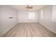 Expansive living area featuring wood-look flooring and contemporary lighting and a ceiling fan at 8084 Bosco Bay Ave, Las Vegas, NV 89113