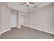 This bedroom features carpet flooring, neutral paint, ceiling fan and mirrored closet at 87 E Agate Ave # 403, Las Vegas, NV 89123