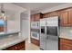 Modern kitchen with stainless steel refrigerator and granite countertops at 87 E Agate Ave # 403, Las Vegas, NV 89123