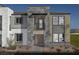 Striking elevation view of townhome with stone and modern design elements, plus small balcony at 871 Apatite Pl # Lot 54, Henderson, NV 89011