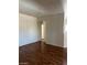 Empty living room featuring hardwood flooring and arched door frame to another room at 9000 Las Vegas Blvd # 2189, Las Vegas, NV 89123