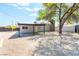 Backyard showcasing the covered patio, storage shed, mature trees, and a low-maintenance gravel landscape at 915 Melrose Dr, Las Vegas, NV 89101