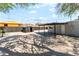 Spacious backyard featuring gravel, a storage shed, covered patio, and a well-maintained exterior at 915 Melrose Dr, Las Vegas, NV 89101