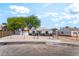Charming single-story home featuring a fenced yard, freshly painted exterior, and mature trees under a blue sky at 915 Melrose Dr, Las Vegas, NV 89101