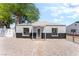Charming single-story home featuring a freshly painted exterior and a well-maintained front yard under a blue sky at 915 Melrose Dr, Las Vegas, NV 89101