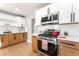 Close-up of kitchen featuring stainless steel stove, white tile backsplash, and wood cabinets at 915 Melrose Dr, Las Vegas, NV 89101