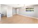 Open-concept living area featuring modern light fixture, wood-look floors, and a convenient laundry area at 915 Melrose Dr, Las Vegas, NV 89101