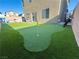 Turf backyard boasts putting green, grill and is fully fenced with easy slider door access at 9648 Spyglass Run Ave, Las Vegas, NV 89178