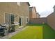 Turf backyard featuring a built-in BBQ, grill, and easy access sliding glass doors at 9648 Spyglass Run Ave, Las Vegas, NV 89178