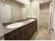 A full bathroom with double sinks, granite countertops and tile floors at 9648 Spyglass Run Ave, Las Vegas, NV 89178
