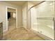 Bathroom with tiled floors, a glass-enclosed shower, and access to a walk-in closet at 9648 Spyglass Run Ave, Las Vegas, NV 89178