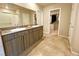 Bathroom featuring a double vanity, tiled floors, and access to a walk-in closet at 9648 Spyglass Run Ave, Las Vegas, NV 89178