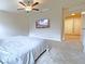Primary bedroom with a ceiling fan, TV, and ensuite bathroom at 9648 Spyglass Run Ave, Las Vegas, NV 89178